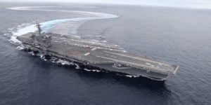 US Navy Aircraft carrier makes tight turns.